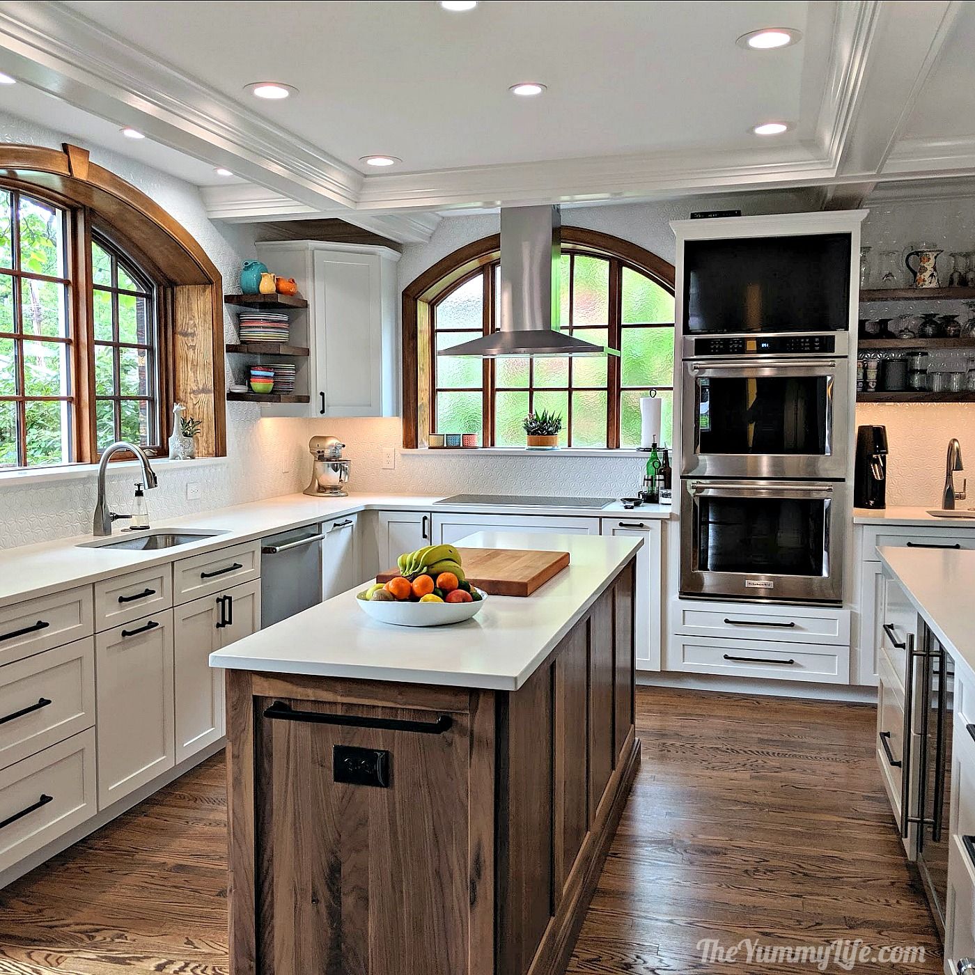 Craftsman kitchen with arched windows, walnut island, and open shelving
