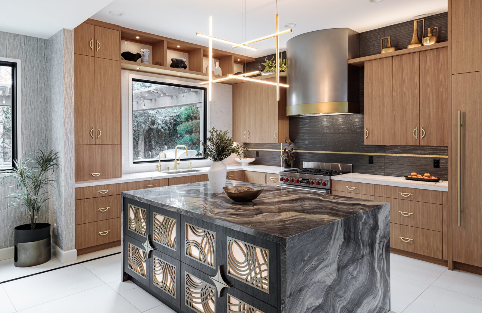 Designer kitchen with art deco island, statement stone, and brass accents