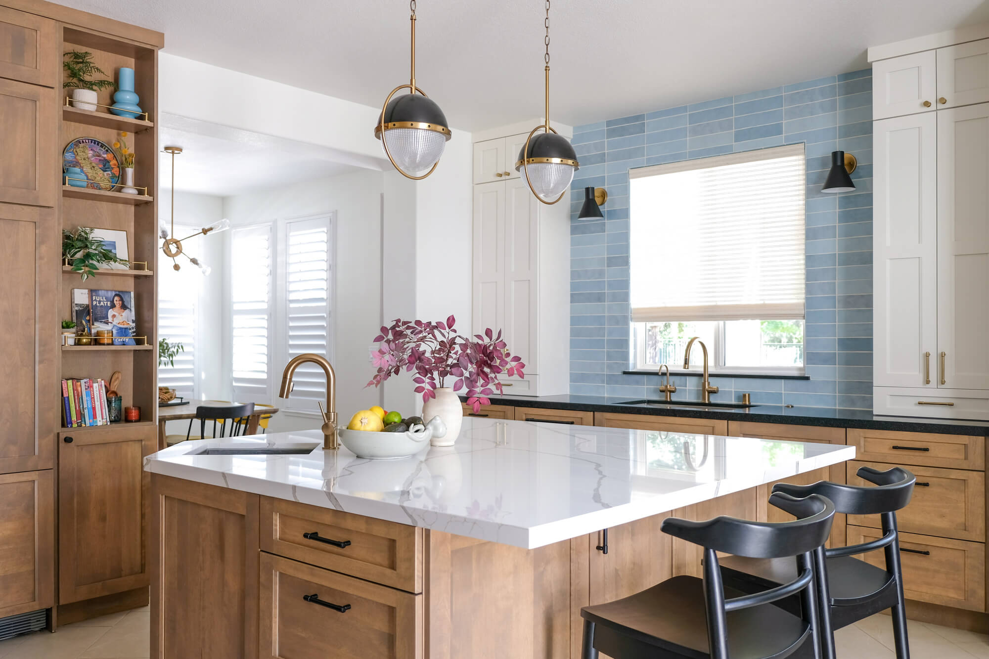 Warm wood kitchen with blue subway tile backsplash and brass fixtures
