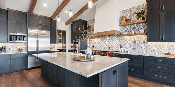 Expansive kitchen with dark cabinetry, open shelving, and decorative tile