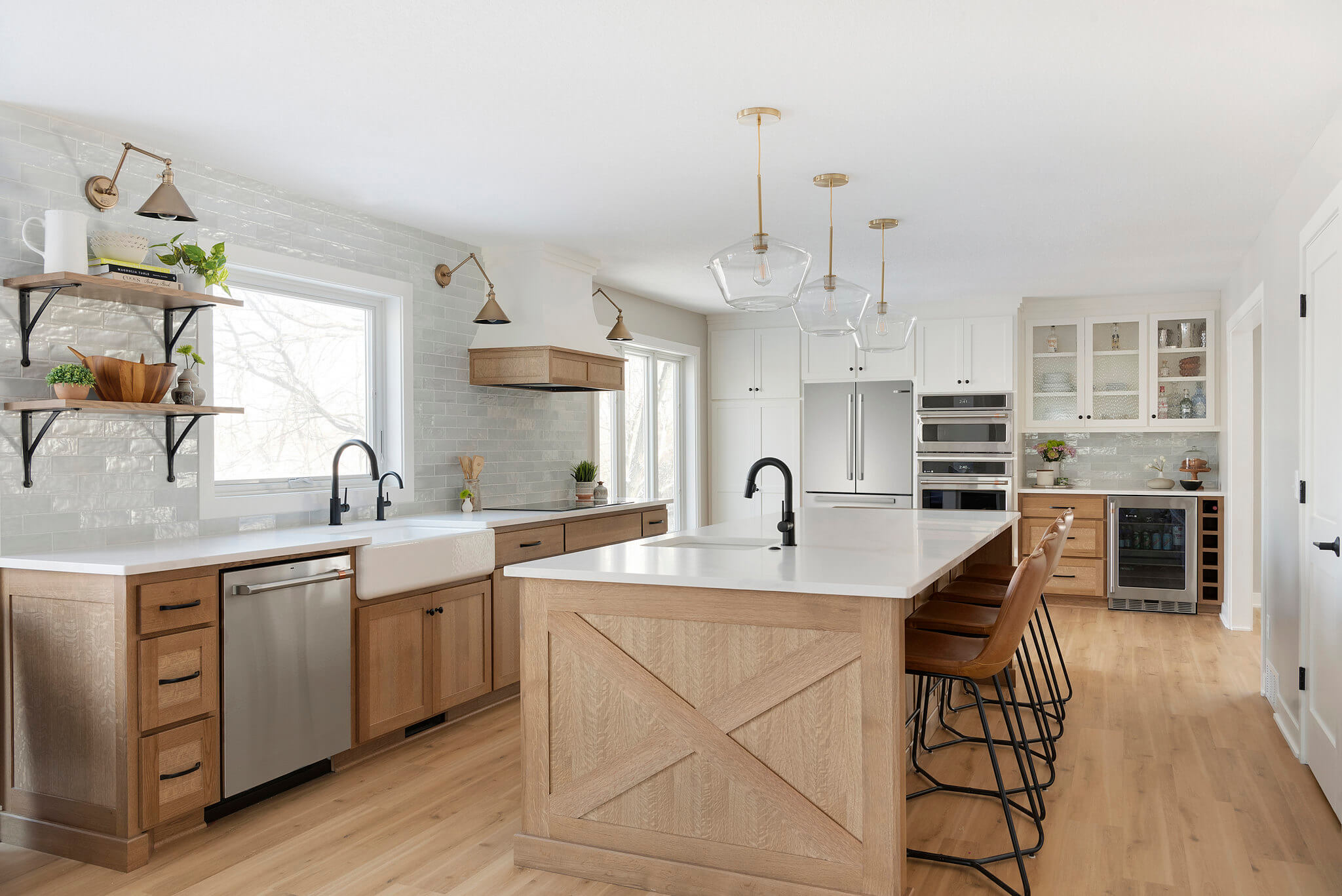 Farmhouse kitchen with white oak island, subway tile, and glass pendants